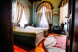 Katil atau katil-katil dalam bilik di Antique House Hotel