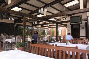 a restaurant with tables and people sitting at tables at Cazare Turn Sebes in Sebeş