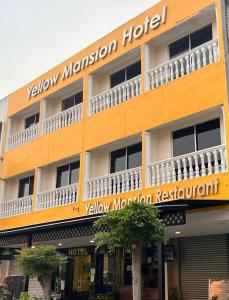 a yellow mansion hotel with a sign on it at Yellow Mansion Hotel Melaka Raya in Melaka