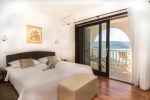 Postel nebo postele na pokoji v ubytování Hotel Vila Tina