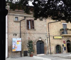 a large brick building with a black door at La terrazza sul borgo in Serracapriola