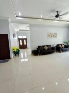 a living room with couches and a ceiling at Cassa Villa Guest House Pasir Mas in Pasir Mas +21 photos