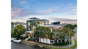 an apartment building with a car parked in front of it at Sandcastles in Casuarina