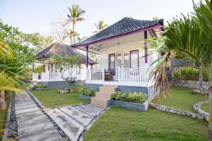 a house with a garden in front of it at Akusara Jungle Resort And Spa in Nusa Penida