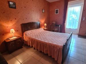 a bedroom with a large bed and a window at Gîte et camping à la ferme avec espace détente - Profitez de la campagne du Berry - FR-1-591-558 in La Berthenoux