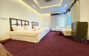 a large hotel room with two beds and a couch at Avasta Resort Wijaya Leisure in Anuradhapura +47 photos