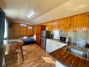 a kitchen with a sink and a kitchen with a bed at BIG4 Red Cliffs Caravan Park in Red Cliffs