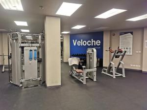 a gym with two exercise machines and a sign at Veloche Karon 12 in Karon Beach +20 photos