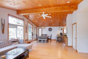 a living room with a couch and a ceiling fan at Cozy cottage on a private beach -Georgian Bay in Tiny