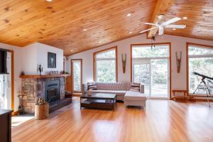 a living room with a couch and a fireplace at Cozy cottage on a private beach -Georgian Bay in Tiny