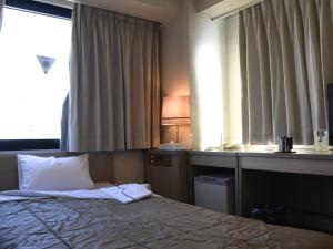Postel nebo postele na pokoji v ubytování Silk Hotel