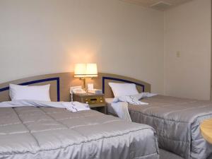 Postel nebo postele na pokoji v ubytování Silk Hotel