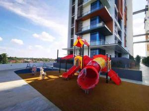 a playground in front of a apartment building at Hanns modern paradise in Sibu