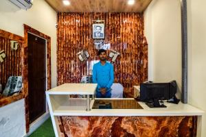 a man is sitting in a room with a desk at Hotel O Kanchan Residency in Kota +34 photos