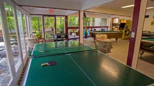 a room with a pool table with a cue on it at Whispering Bears Chalet in Gatlinburg