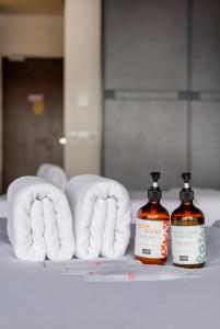 a shelf with towels and two bottles of soap at Ceylonz KLCC by Gsuites in Kuala Lumpur
