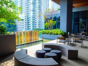 a patio with chairs and tables in a building at Ceylonz KLCC by Gsuites in Kuala Lumpur