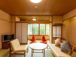 a living room with a couch and a table at Hibikino in Shibukawa +56 photos