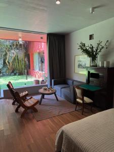a room with a bed and a couch and a table at Parque Juan Diego in Guadalajara