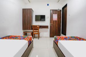Postel nebo postele na pokoji v ubytování FabHotel Elvis Inn - Nr Mumbai International Airport