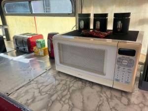 a microwave with two cups on top of it on a counter at Decker Daze Queenstown in Queenstown
