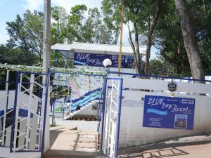 a gate to a play park with a roller coaster at BLUE Bay resorts in Yelagiri +25 photos