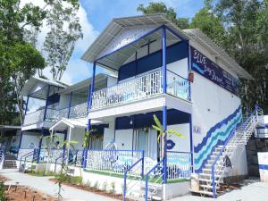 a blue and white building with blue stairs at BLUE Bay resorts in Yelagiri