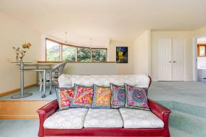 a living room with a couch and a table at Sea views from holiday home in Lower Hutt +59 photos