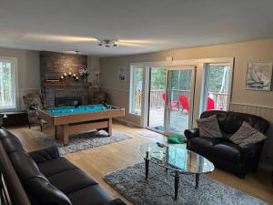 a living room with a pool table in it at Ultimate Lakeview Retreat - Hot Tub, Paddle & Play in Bancroft