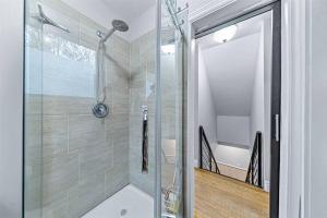 a shower with a glass door in a bathroom at Ultimate Lakeview Retreat - Hot Tub, Paddle & Play in Bancroft +50 photos