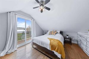 a bedroom with a bed and a ceiling fan at Ultimate Lakeview Retreat - Hot Tub, Paddle & Play in Bancroft
