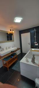 a bathroom with two sinks and a bath tub at Stilvoll & Wohlfühlfaktor! in Nohfelden +16 photos