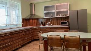 a kitchen with a table and a refrigerator at Villa Green Olive Bar in Šušanj