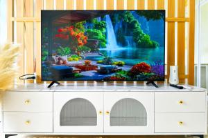 a tv screen on a dresser with a waterfall at Scenic Condo 50 sqm Karon in Karon Beach