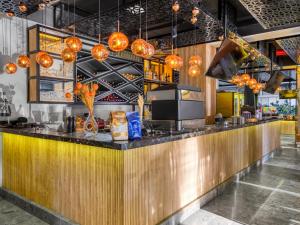 a bar in a restaurant with orange lights at Aria Riva Apart Hotel in Alanya