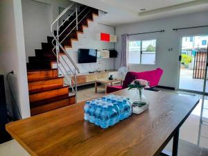 a table with water bottles on it in a living room at MikaHouse in Betong