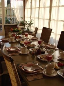 a long table with plates and wine glasses on it at Les Demoiselles de Ladoix in Ladoix Serrigny +17 photos
