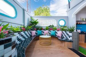 a balcony with a table and chairs and plants at Villa VTS - Gần Biển Thùy Vân - Free Karaoke in Vung Tau