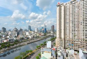 a view of a city with a river and buildings at Căn hộ Rivergate - Sài Gòn, Quận 4 in Ho Chi Minh City