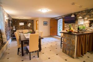 a dining room and kitchen with a table and chairs at Villa Vita in Polje