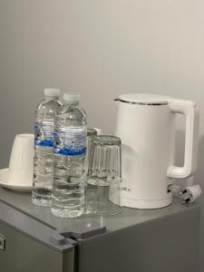 two bottles of water sitting on top of a counter at Maland House Hostel - Pattaya soi 14 Saisong Road in Pattaya South
