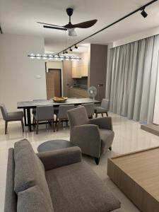 a living room with a dining room table and chairs at Ruma Langkawi in Kuah