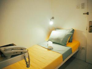 a hospital room with a bed with a phone on it at Wanderlust Bed and Breakfast Puerto Princesa in Puerto Princesa City
