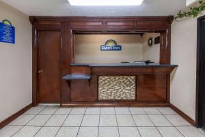 a front door of a dogs inn with a sign on it at Days Inn by Wyndham El Reno in El Reno