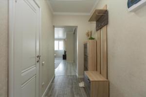 a room with a hallway with a door and a kitchen at Ушсункар Nice in Almaty +3 photos