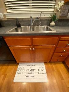 a kitchen sink with a sign on the floor at Cozy Two Bedrooms House in Beaverton in Beaverton