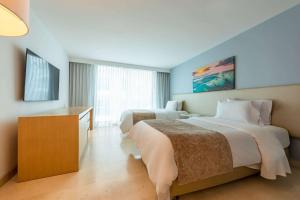 Кровать или кровати в номере Radisson Cartagena Ocean Pavillion Hotel