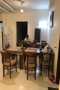 a man sitting at a table in a dining room at Hotel Dior Near Jal Mahal, Jaipur in Jaipur