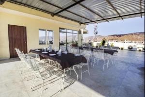 a dining room with tables and white chairs at Hotel Dior Near Jal Mahal, Jaipur in Jaipur