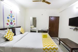 a bedroom with a large bed with yellow and white pillows at Hotel Dior Near Jal Mahal, Jaipur in Jaipur +36 photos